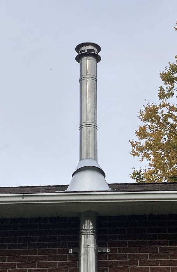 Chimney cap installation detail on brick building