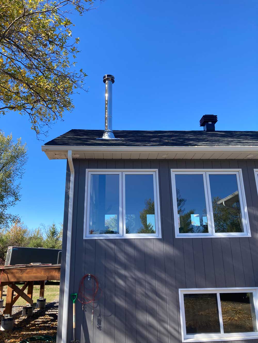 Chimney installation on small building exterior